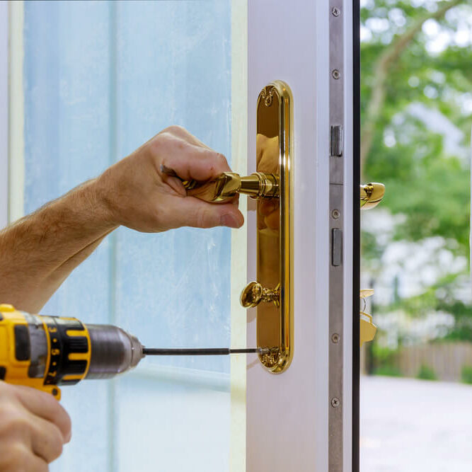 stock-photo-professional-locksmith-installing-or-new-lock-on-a-house-door-handle-with-screwdriver-1796924725 (1)